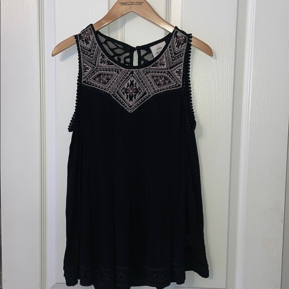 a black tank top with detailing on top.